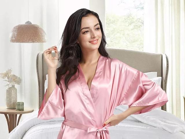 A bride and her friends in matching pink satin robes